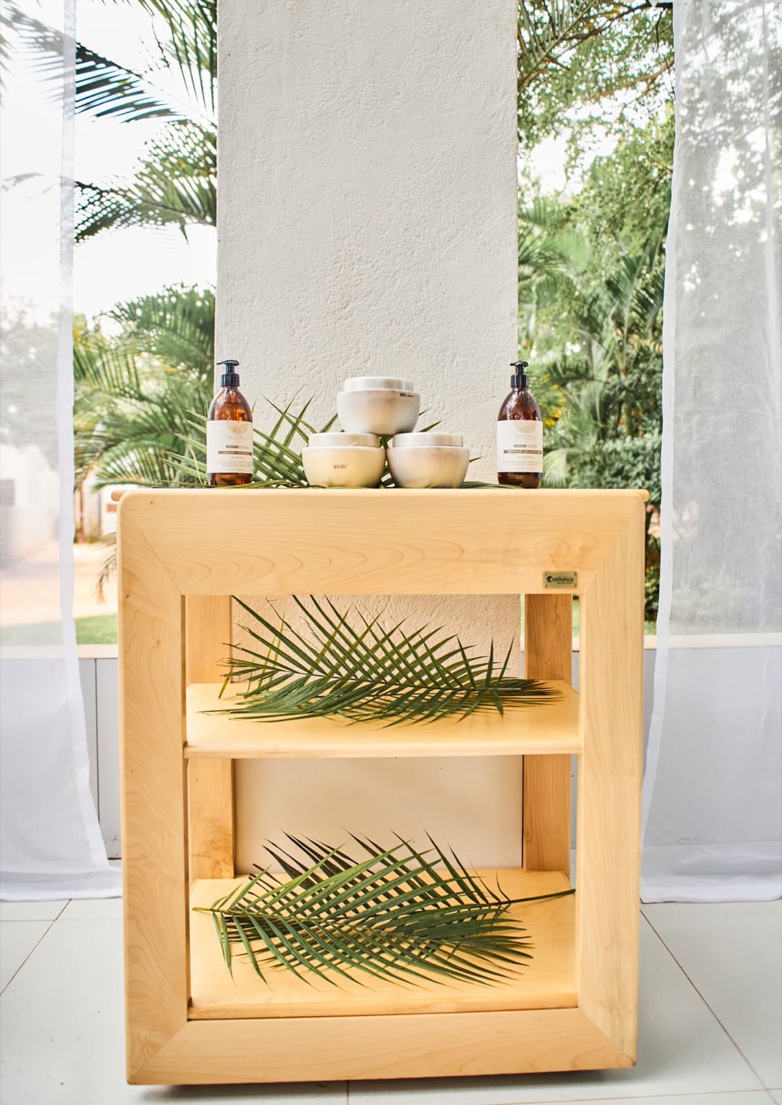 MaMoyo spa products on a wooden trolley beside the gardens
