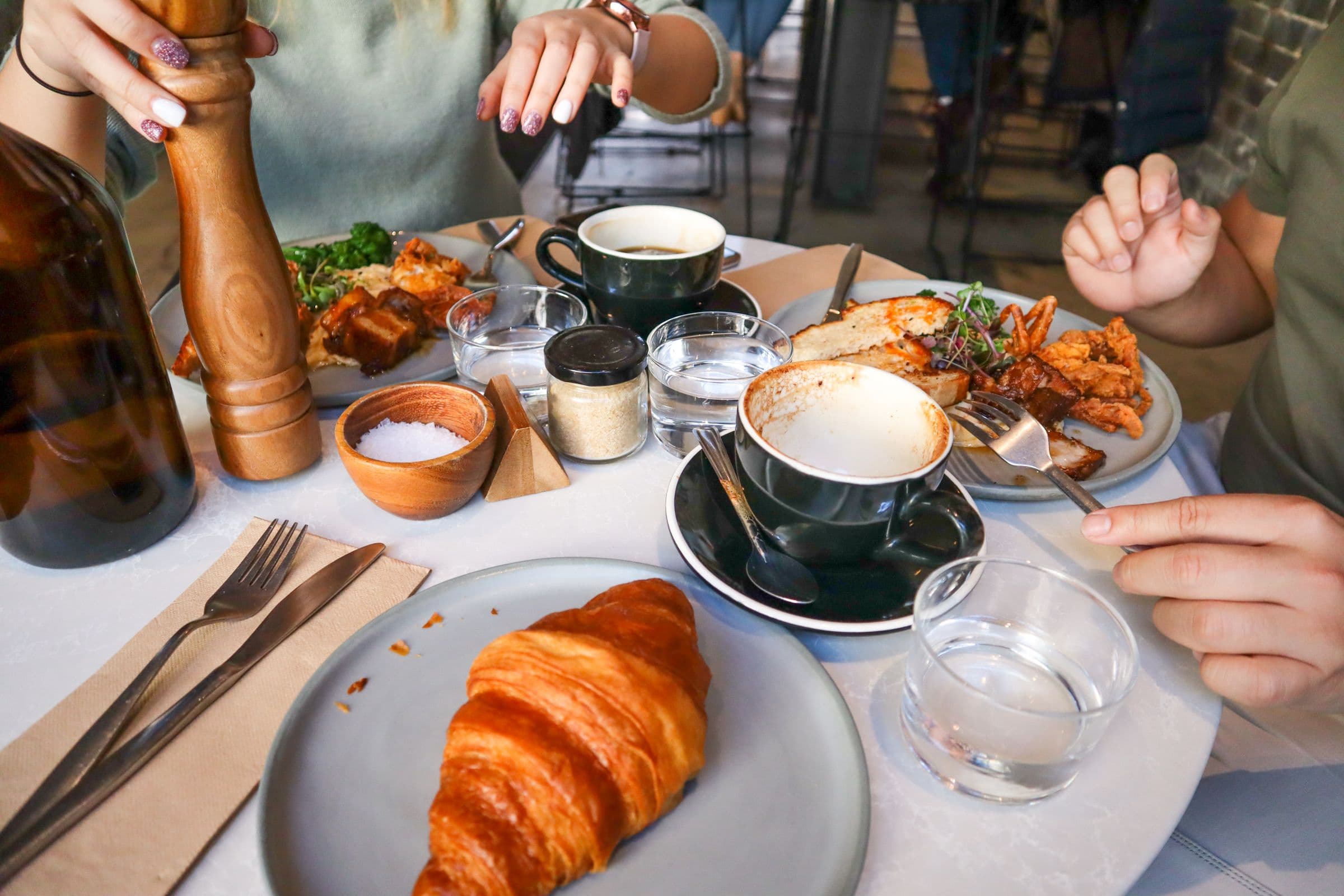 Coffee and pastries on a quiet cafe table